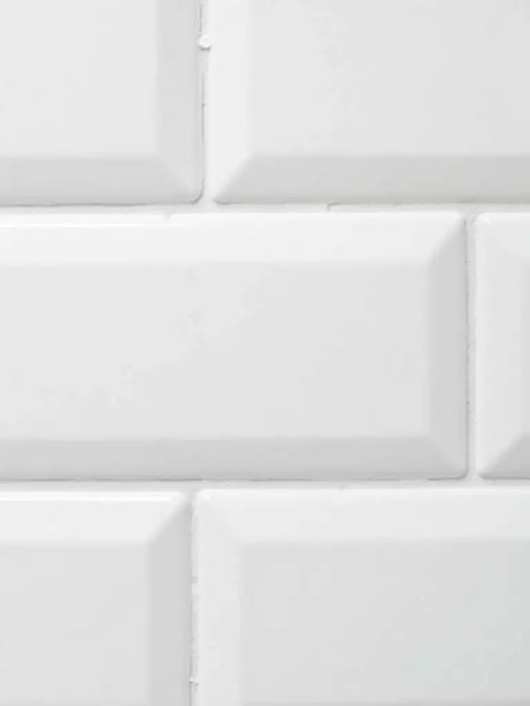 Bathroom tiles with freshly cleaned bright white grout, a simple way to refresh tile surfaces.