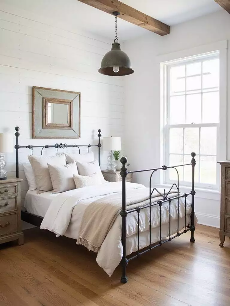 Farmhouse bedroom with wrought iron bed frame and metal accents.