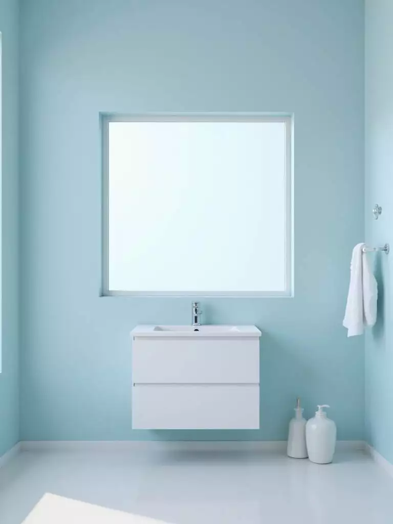 Bright, airy blue bathroom renovation with fresh paint.