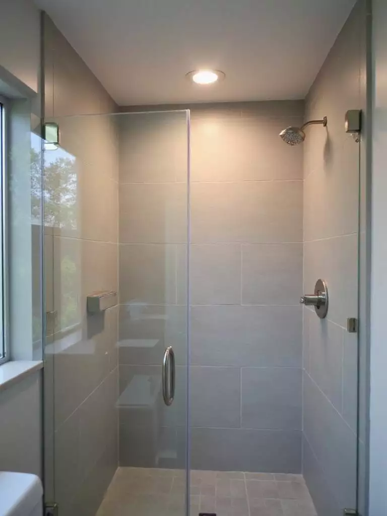 Modern shower with waterproof recessed lighting for safe and ambient illumination.