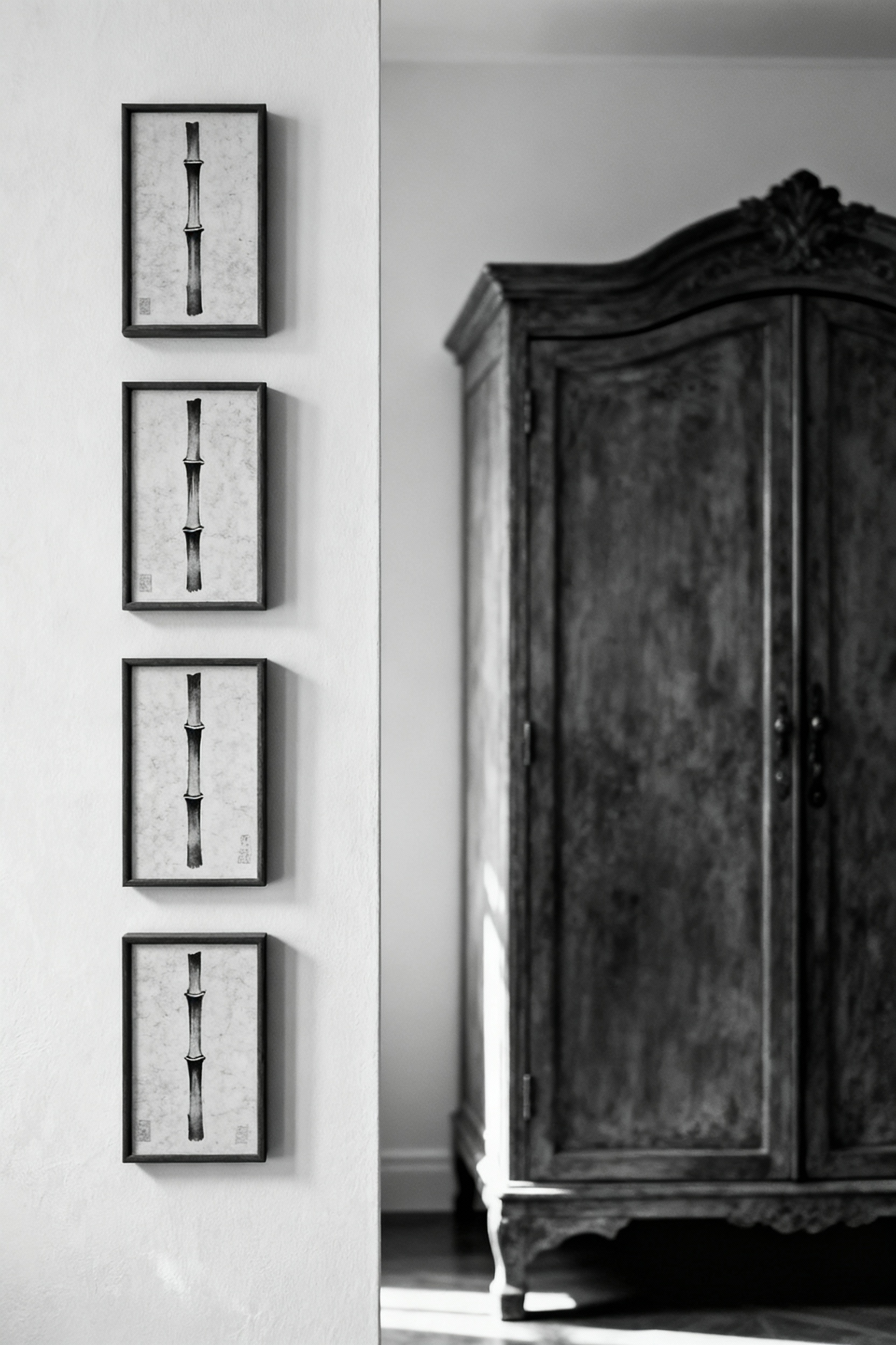 Bedroom with a narrow wall transformed into a vertical gallery featuring four Japanese woodblock prints of bamboo shoots, highlighting effective use of challenging wall space.